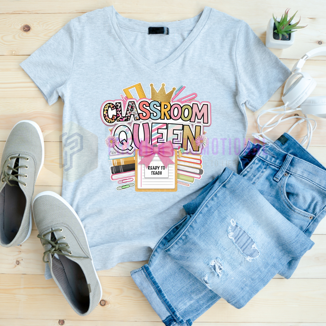 Light blue t-shirt with 'Classroom Queen' design, paired with jeans and shoes on a wooden surface.