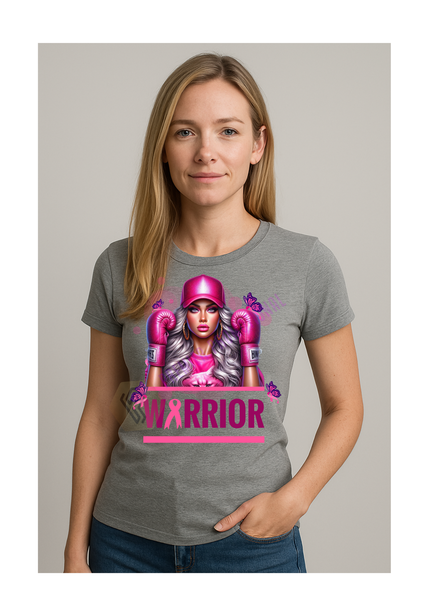 Woman wearing a gray t-shirt with a graphic design of a woman in boxing gloves and a pink warrior graphic.