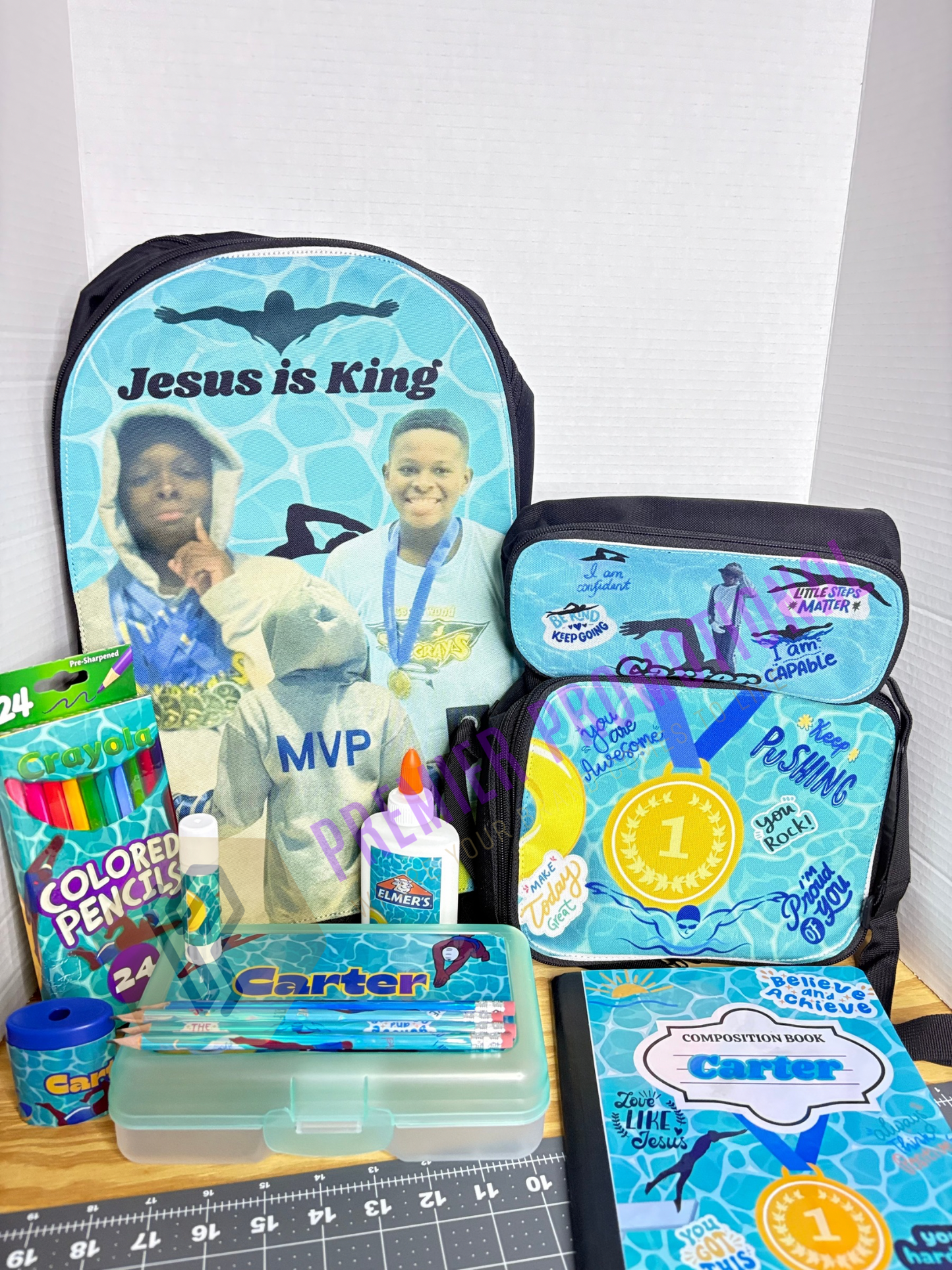 Backpack and school supplies with 'Jesus is King' text on a white background