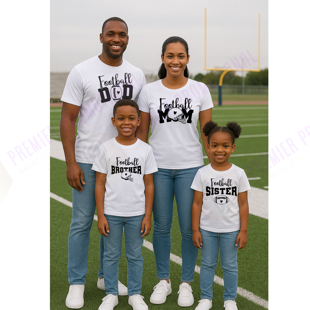 Family of four wearing matching 'Football' themed t-shirts on a sports field.